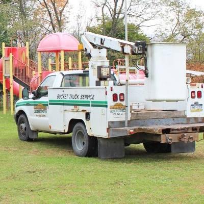 A truck from Shawn Kresge Electric, Heating & AC parked next to a newly built playground
